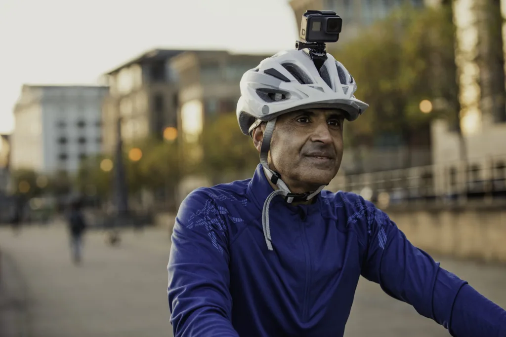 Cyclist wearing helmet-mounted action camera