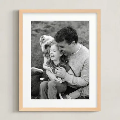 11×14 matted framed photo in natural wood frame with white mat board on a wall