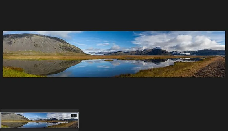 Final stitched mountain lake panorama with source file thumbnail below — Lightroom panorama merge result showing wide 3:1 aspect ratio